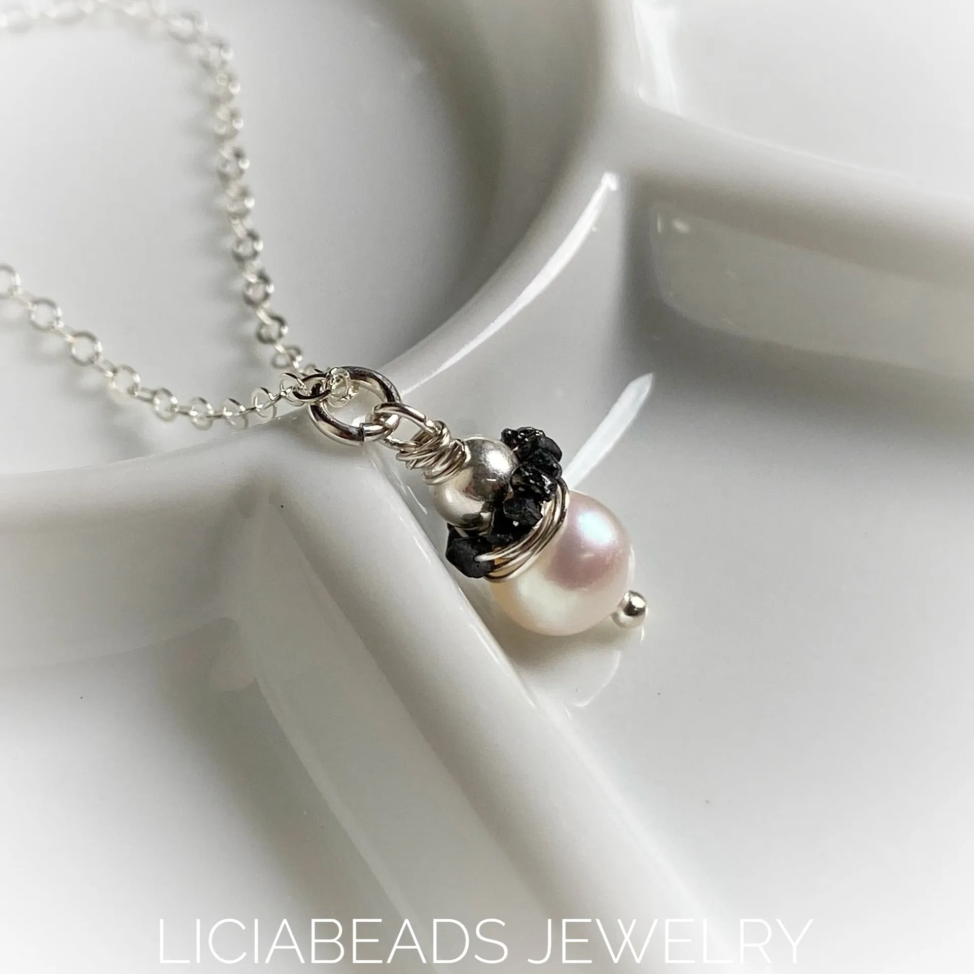 Black diamond nugget encircled freshwater pearl. April and June birthstones.